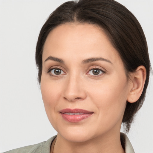 Joyful white young-adult female with medium  brown hair and brown eyes