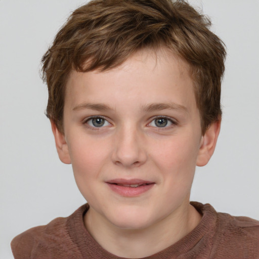 Joyful white child male with short  brown hair and grey eyes