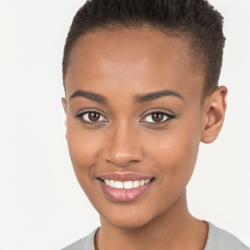 Joyful black young-adult female with short  brown hair and brown eyes