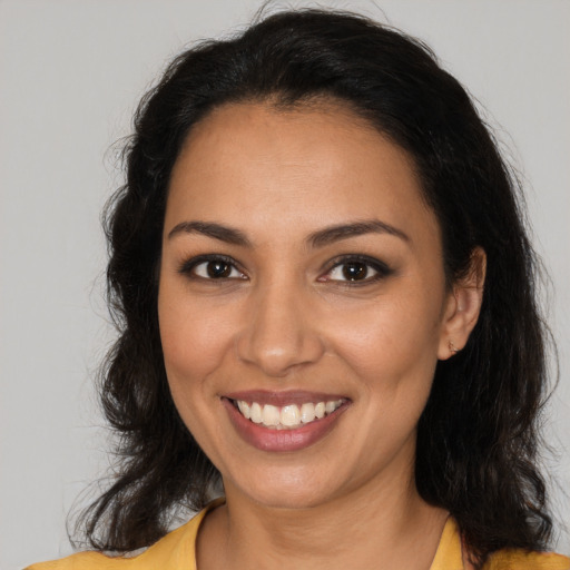 Joyful latino young-adult female with medium  brown hair and brown eyes