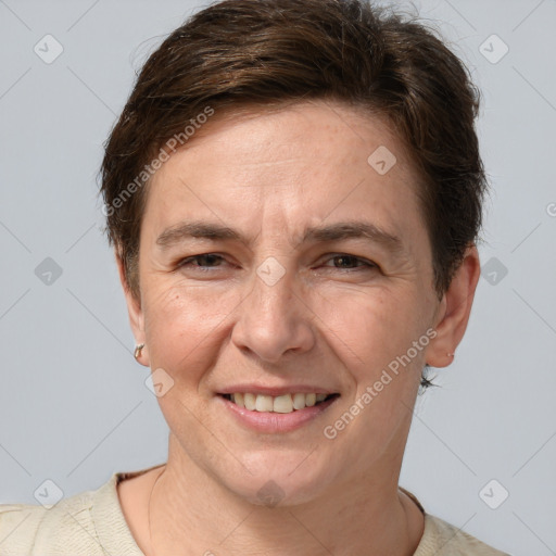 Joyful white adult female with short  brown hair and grey eyes