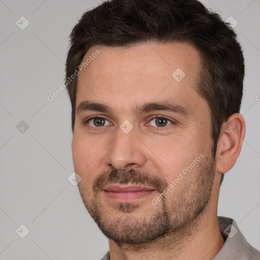 Joyful white adult male with short  brown hair and brown eyes