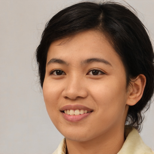 Joyful asian young-adult female with medium  brown hair and brown eyes