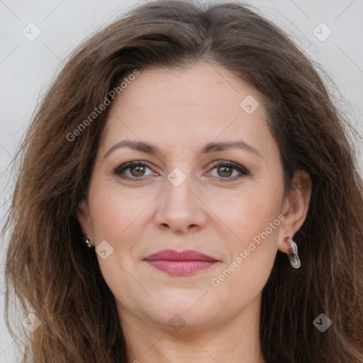 Joyful white adult female with long  brown hair and brown eyes