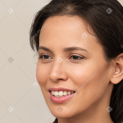 Joyful white young-adult female with long  brown hair and brown eyes