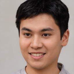 Joyful asian young-adult male with short  brown hair and brown eyes