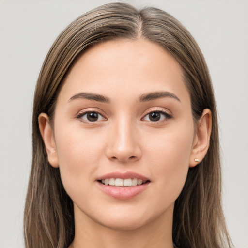 Joyful white young-adult female with long  brown hair and brown eyes