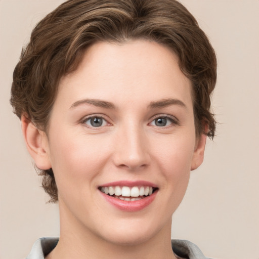 Joyful white young-adult female with short  brown hair and grey eyes