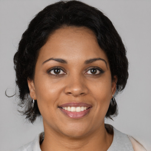 Joyful black young-adult female with medium  black hair and brown eyes