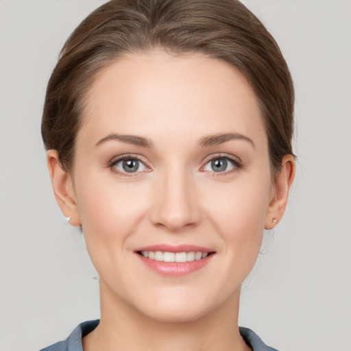 Joyful white young-adult female with short  brown hair and grey eyes