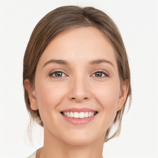 Joyful white young-adult female with medium  brown hair and grey eyes