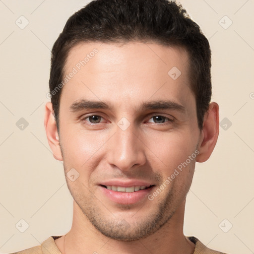 Joyful white young-adult male with short  brown hair and brown eyes