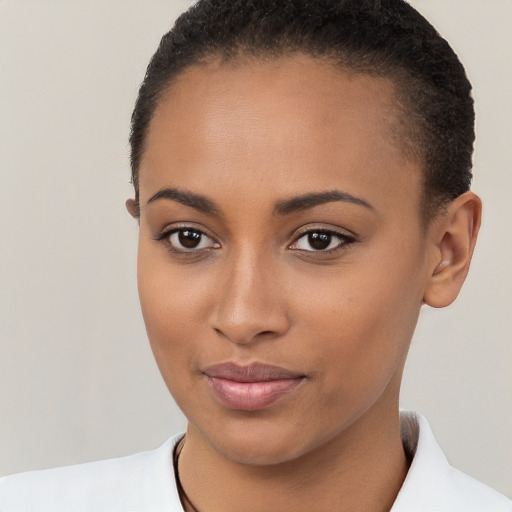 Joyful black young-adult female with short  brown hair and brown eyes