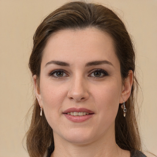 Joyful white young-adult female with long  brown hair and brown eyes