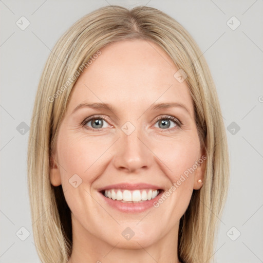 Joyful white adult female with long  brown hair and grey eyes