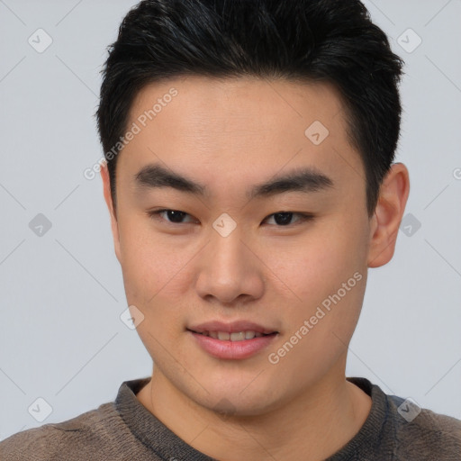 Joyful asian young-adult male with short  black hair and brown eyes