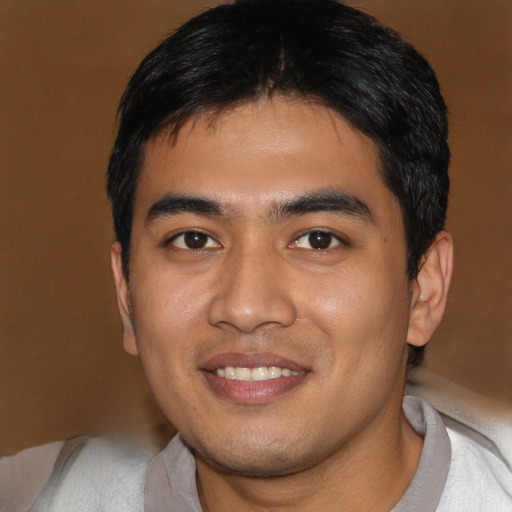 Joyful asian young-adult male with short  black hair and brown eyes