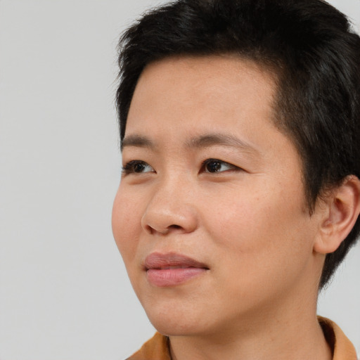 Joyful asian young-adult male with short  black hair and brown eyes