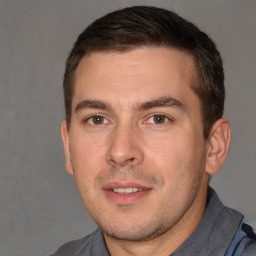 Joyful white adult male with short  brown hair and brown eyes