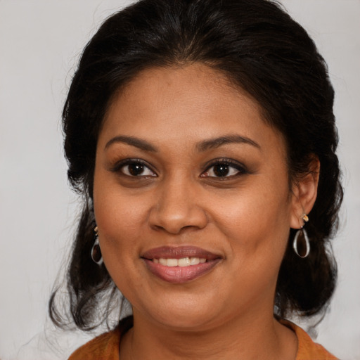 Joyful black young-adult female with medium  brown hair and brown eyes