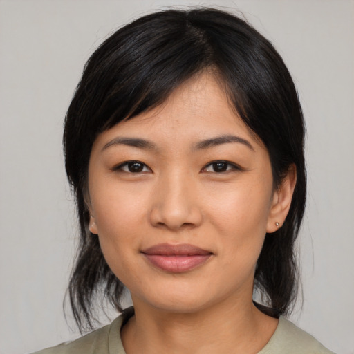 Joyful asian young-adult female with medium  black hair and brown eyes