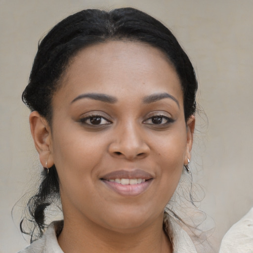 Joyful black young-adult female with medium  brown hair and brown eyes