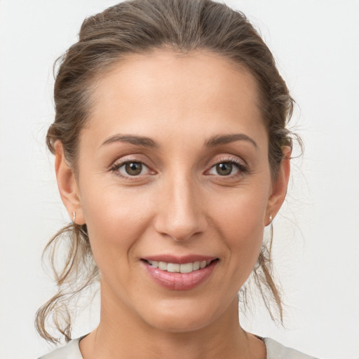 Joyful white adult female with medium  brown hair and brown eyes