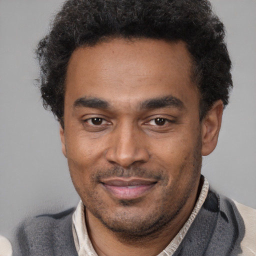 Joyful latino adult male with short  brown hair and brown eyes