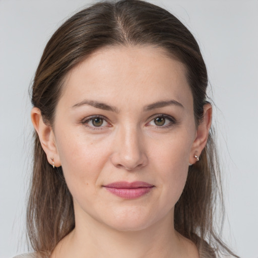 Joyful white young-adult female with medium  brown hair and grey eyes