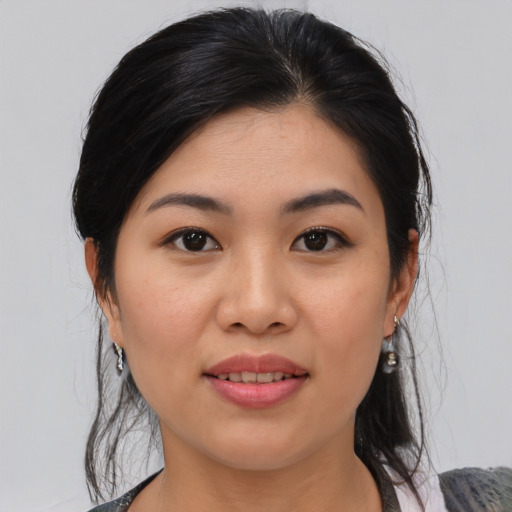 Joyful asian young-adult female with medium  black hair and brown eyes
