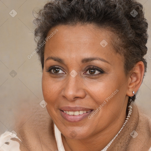 Joyful black adult female with short  brown hair and brown eyes