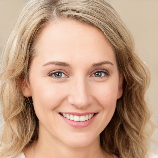 Joyful white young-adult female with long  brown hair and blue eyes