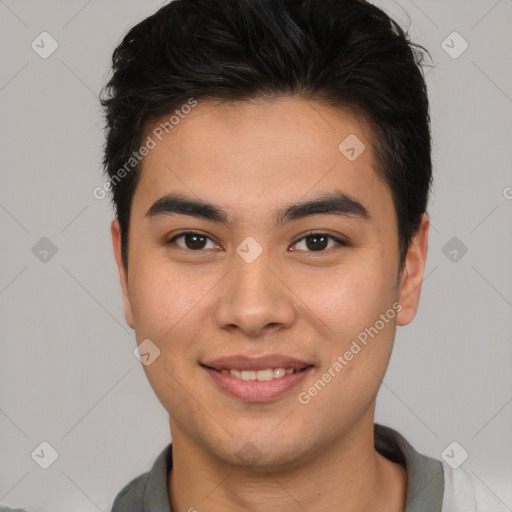 Joyful asian young-adult male with short  brown hair and brown eyes