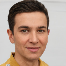 Joyful white young-adult male with short  brown hair and brown eyes