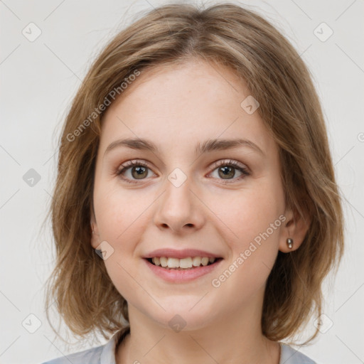 Joyful white young-adult female with medium  brown hair and green eyes