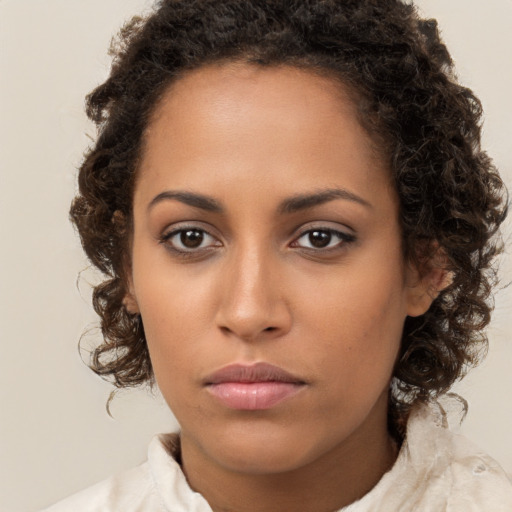 Neutral black young-adult female with medium  brown hair and brown eyes