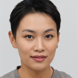 Joyful asian young-adult female with short  brown hair and brown eyes