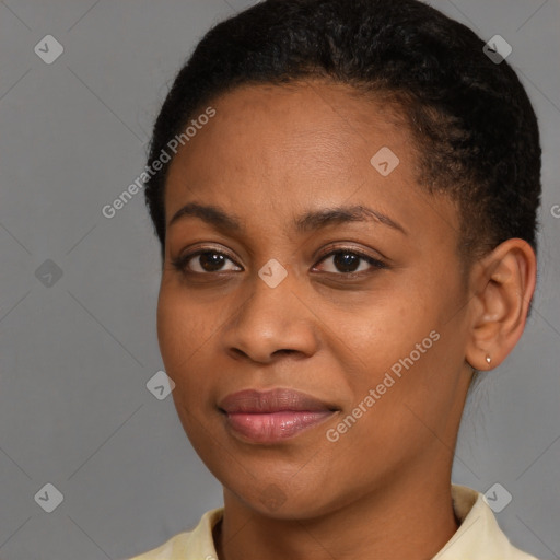 Joyful black young-adult female with short  brown hair and brown eyes