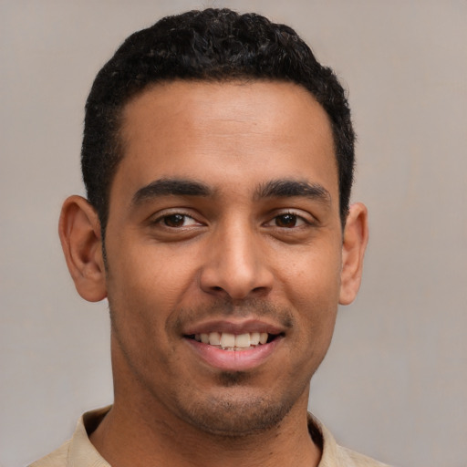 Joyful latino young-adult male with short  brown hair and brown eyes