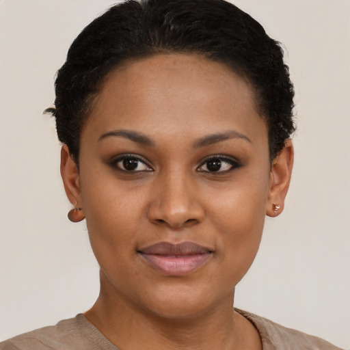 Joyful black young-adult female with short  brown hair and brown eyes