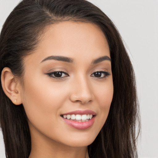 Joyful white young-adult female with long  brown hair and brown eyes