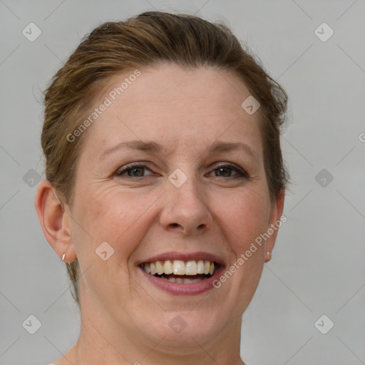 Joyful white adult female with short  brown hair and grey eyes