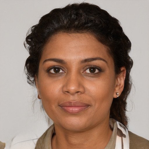 Joyful black young-adult female with medium  brown hair and brown eyes