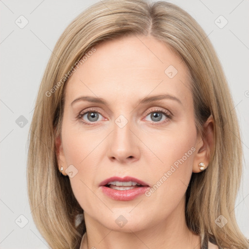 Joyful white adult female with long  brown hair and blue eyes