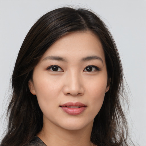 Joyful asian young-adult female with long  black hair and brown eyes