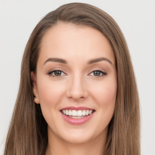 Joyful white young-adult female with long  brown hair and grey eyes