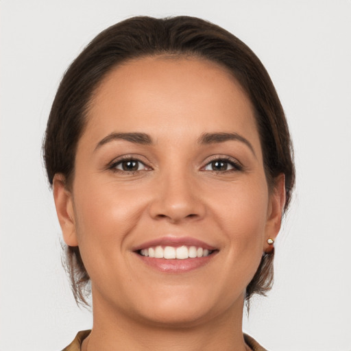 Joyful white young-adult female with long  brown hair and brown eyes