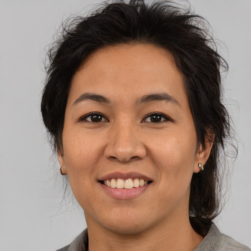 Joyful asian adult female with medium  brown hair and brown eyes