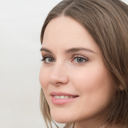 Joyful white young-adult female with long  brown hair and grey eyes