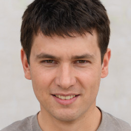 Joyful white adult male with short  brown hair and brown eyes